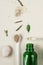 Minimal style. Natural cosmetics, handmade skin and body care. green bottle with peep and plants. Flat lay