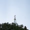 Minimal view over the top of a church at the end of the day, white cross in blue sky, Madeira, Portugal