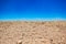 Minimalism landscape of desert wasteland dry stone ground nature background horizontal board with empty blue sky empty copy space