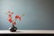 minimalism photo modern black vase with red flowers on a table with copy space
