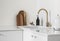 Minimalism simplicity kitchen interior - white ceramic sink with dispenser, dish brushes, electric kettle on a white table