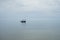 Minimalism style picture,traditional fishing boat float on a peace surface wave of the sea,cloudy sky