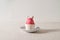 Minimalist aesthetic Easter holiday concept, pink colored egg in cup with bunny ears on plate, on neutral beige linen