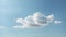 Minimalist background with a tranquil, pale blue sky and a solitary, wispy cloud.