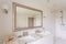 Minimalist bathroom with large mirror