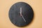 Minimalist black wall clocks on brown background