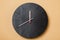 Minimalist black wall clocks on brown background