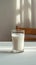 Minimalist charm Glass of milk on a white table