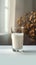 Minimalist charm Glass of milk on a white table