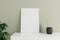 Minimalist and clean vertical white poster or photo frame mockup on the white table leaning against the room wall with vase and