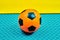 Minimalist composition with vivid colors of an orange soccer ball