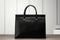 Minimalist elegance Black bag against a white wooden tabletop