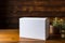 Minimalist elegance White paper box on a natural wood background