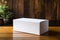 Minimalist elegance White paper box on a natural wood background