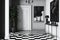 A minimalist entryway with black and white checkered flooring, white walls and a blank poster hanging on the wall