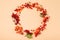 Minimalist fall autumn flat lay with wreath berries on biege background