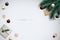 Minimalist festive banner with realistic fir branches, gift box, shiny baubles, gold snowflakes and space for text.