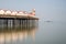 Minimalist fine art landscape image of colorful pier in juxtaposition with old derelict pier in background