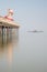 Minimalist fine art landscape image of colorful pier in juxtaposition with old derelict pier in background