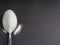 Minimalist flat lay composition sugar and spoon on the dark background.