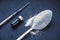 Minimalist flat lay composition sugar, spoon, syringe and vials on the dark background. Medical, Healthcare and Diabetes Concept.