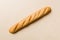 Minimalist french baguette on colored background. fresh bread as background, top view with space for your text or design