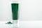 minimalist glass with water and spirulina powder