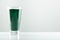 minimalist glass with water and spirulina powder