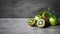 Minimalist Green Apple And Kiwi On Gray Stone Background