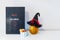 Minimalist Halloween decor - letter board with Hello Halloween message, witch hat on decorative pumpkin and cup with