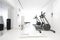 Minimalist home gym with white walls, rubber flooring, and state-of-the-art exercise equipment. Generative AI