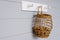 The minimalist interior design of the kitchen is decorated with a hanging white hanger and a basket of walnuts on a gray
