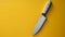 Minimalist Knife On Yellow Wall