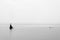 Minimalist landscape image of shipwreck ruin in sea black and white