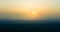 A minimalist landscape of a misty sunrise in summer with a far horizon.