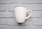 Minimalist mockup of a white ceramic cup on the grey stone background