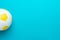 Minimalist photo of soccer ball over turquoise blue background with copy space