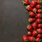 Minimalist presentation of strawberries on textured slate surface