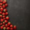 Minimalist presentation of strawberries on textured slate surface