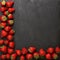 Minimalist presentation of strawberries on textured slate surface