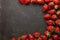 Minimalist presentation of strawberries on textured slate surface