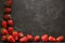 Minimalist presentation of strawberries on textured slate surface