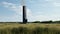 Minimalist Sculpture: Tall Chimney In Grass With Black Sky