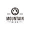 Minimalist seal emblem mountain bike logo, with bicycle crank and mountain vector icon