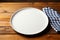 Minimalist setting White plate tray on wooden tablecloth, top view