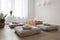 minimalist sitting room with floor cushions, candles, and fresh flowers for a relaxing and peaceful atmosphere