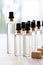 Minimalist Skincare Serum Vials on Wooden Table