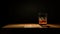 Minimalist Whiskey Glass On Dark Table: A Dramatic Composition