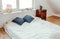 Minimalist white bed mattress on solid hardwood oak floor in cozy modern home bedroom.