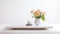 A minimalist white coffee table, adorned with a vibrant vase of orange flowers and a soothing cup of coffee, exuding a sense of